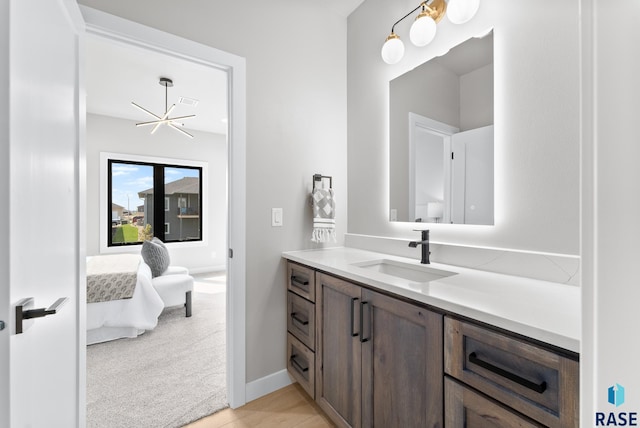 bathroom featuring vanity and a chandelier