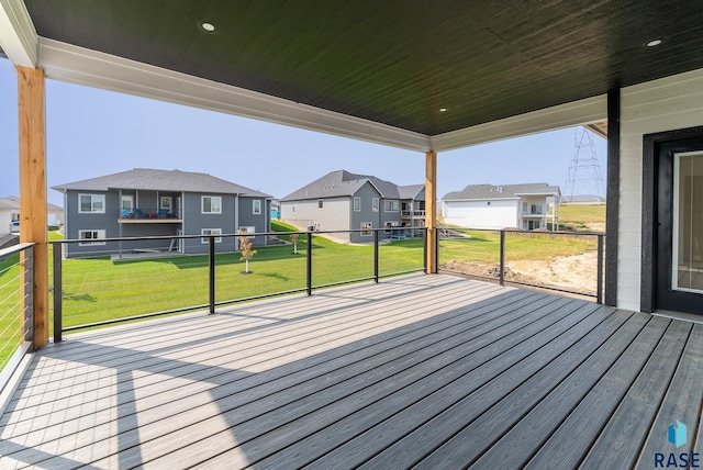 wooden terrace with a lawn