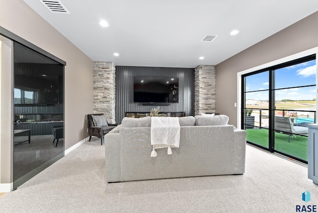 living room featuring light carpet and a fireplace