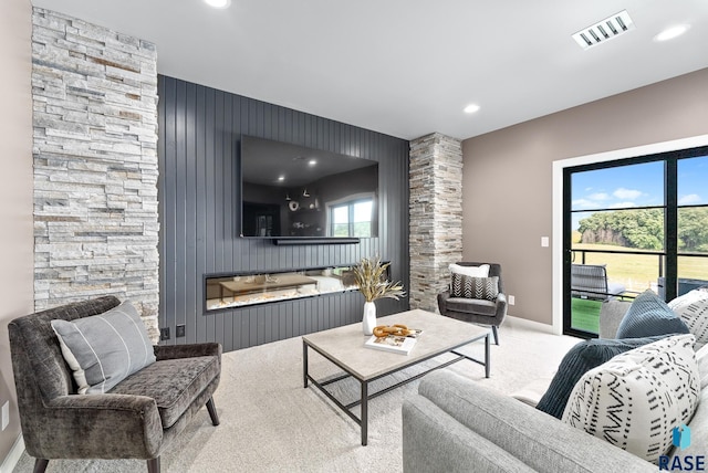 living room with a fireplace and carpet flooring