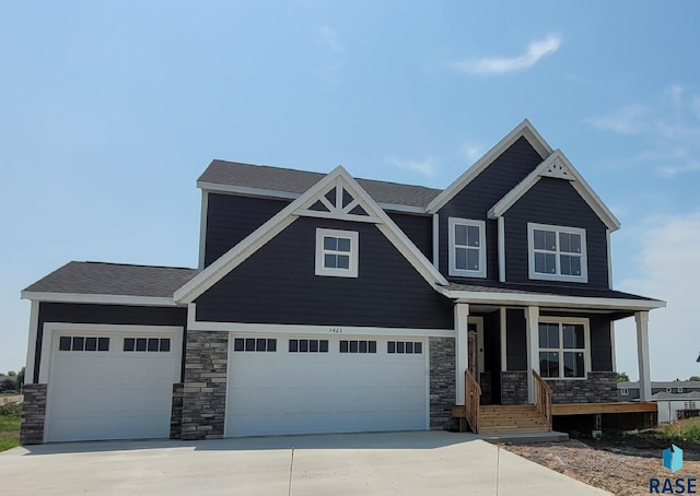 craftsman house featuring covered porch and a garage