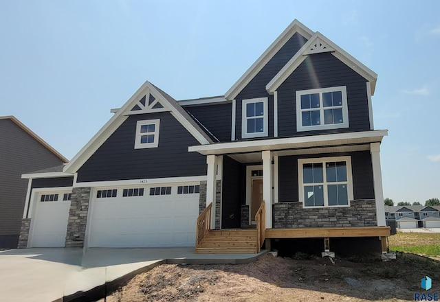 craftsman-style house featuring a garage and covered porch