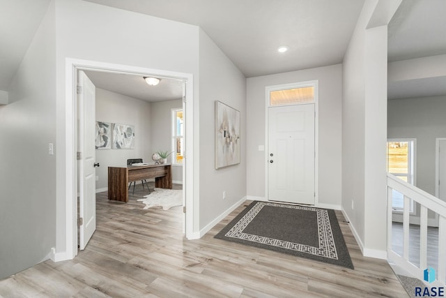 foyer entrance with light hardwood / wood-style flooring