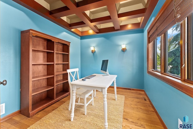 office area with coffered ceiling, beam ceiling, and light hardwood / wood-style flooring