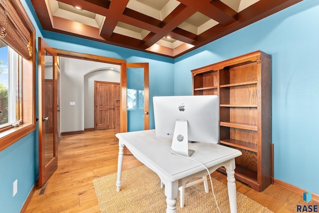 home office featuring coffered ceiling, beamed ceiling, and light hardwood / wood-style floors