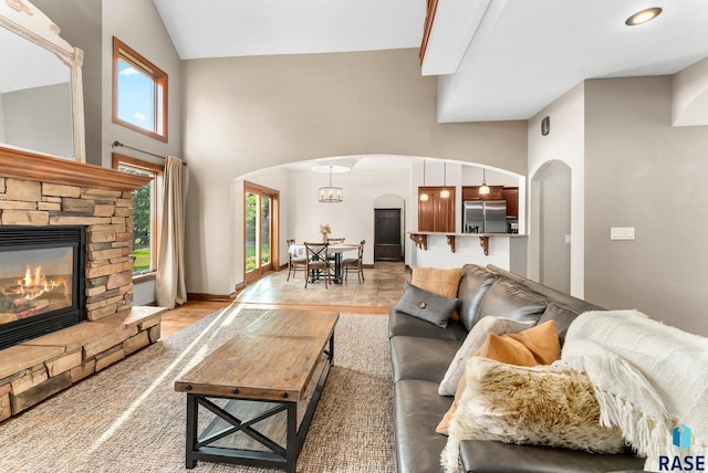 living room with lofted ceiling and a fireplace