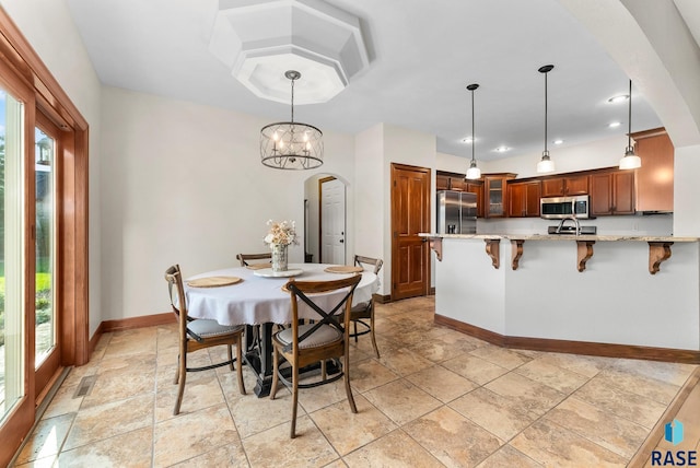 dining area with a wealth of natural light and an inviting chandelier