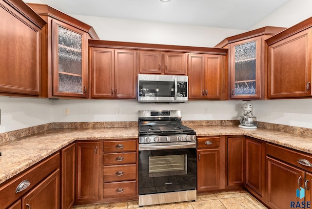 kitchen featuring light stone counters and stainless steel appliances