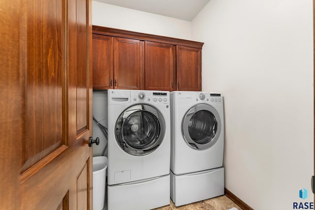 washroom featuring cabinets and washing machine and dryer