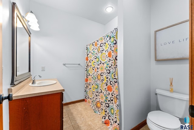 bathroom featuring vanity, toilet, a shower with curtain, and tile patterned floors