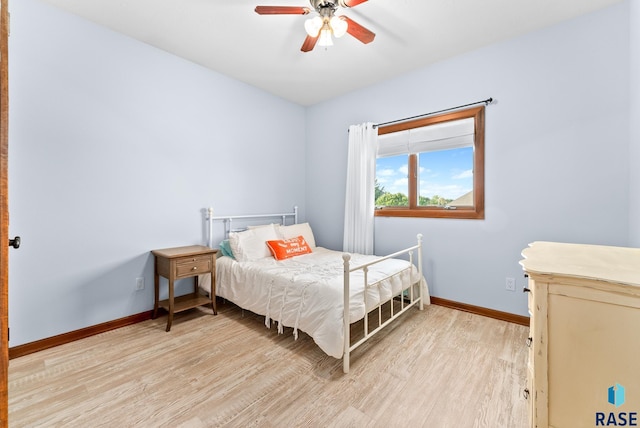 bedroom with light wood-type flooring and ceiling fan