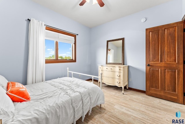 bedroom with light wood-type flooring and ceiling fan