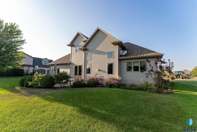 rear view of house with a lawn