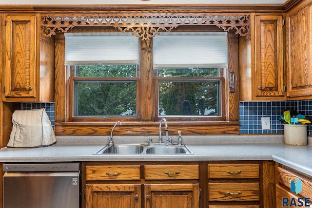 kitchen featuring backsplash, dishwasher, sink, and a wealth of natural light