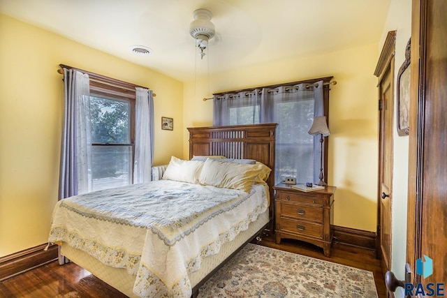 bedroom with dark wood-type flooring and ceiling fan