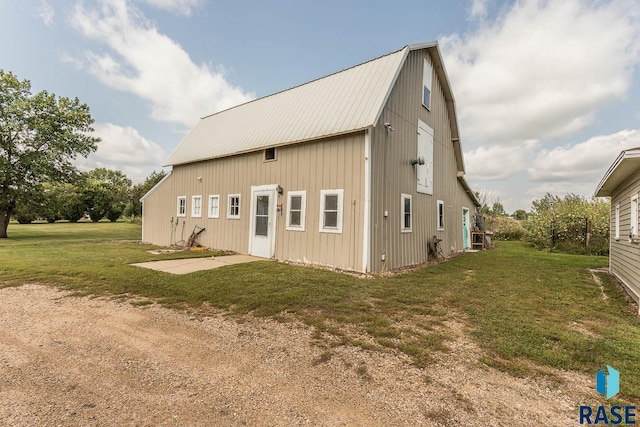 rear view of house featuring a lawn