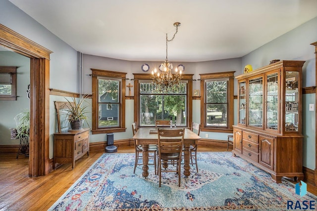 dining area featuring a notable chandelier and light hardwood / wood-style floors