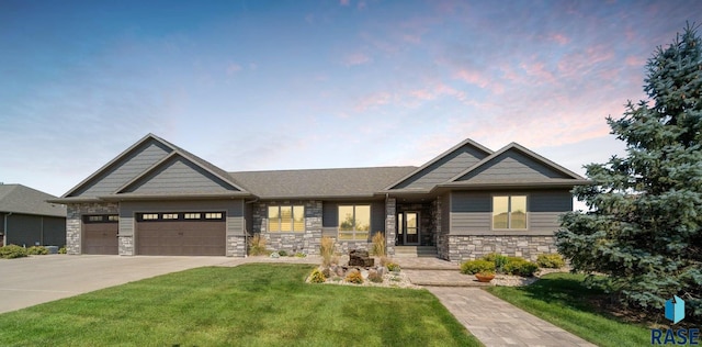 craftsman house with a garage and a yard