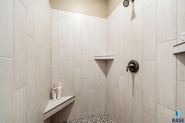 bathroom with tiled shower