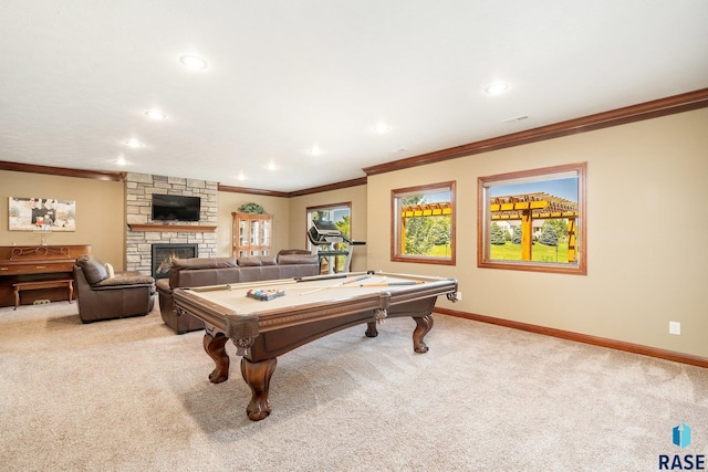 recreation room with ornamental molding, a stone fireplace, light colored carpet, and pool table