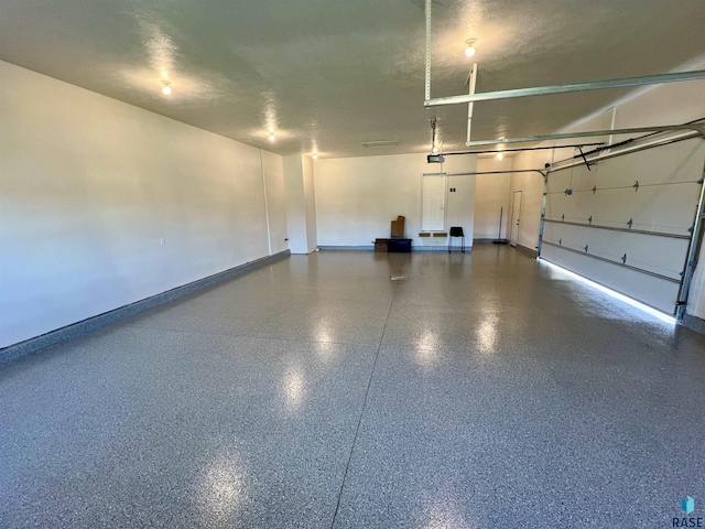 garage featuring baseboards and a garage door opener