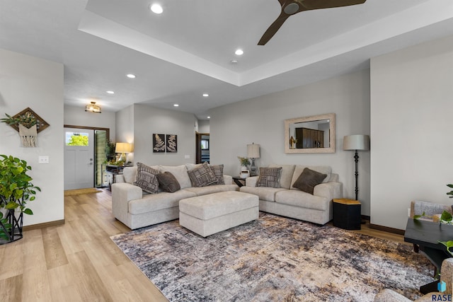 living room featuring baseboards, a ceiling fan, light wood-style floors, and recessed lighting