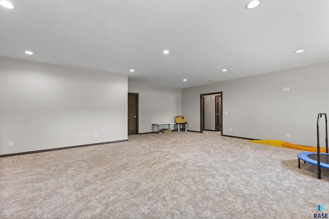 interior space with baseboards, carpet floors, and recessed lighting