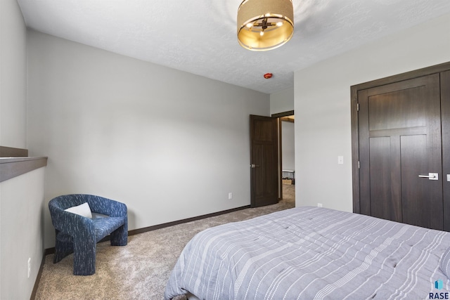 bedroom featuring a closet, carpet flooring, and baseboards