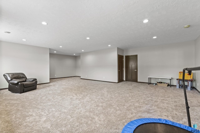 unfurnished room featuring recessed lighting, carpet floors, a textured ceiling, and baseboards