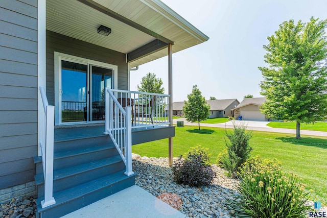 entrance to property featuring a yard