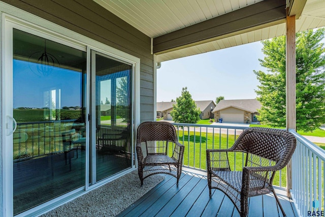 wooden terrace with a lawn and a residential view