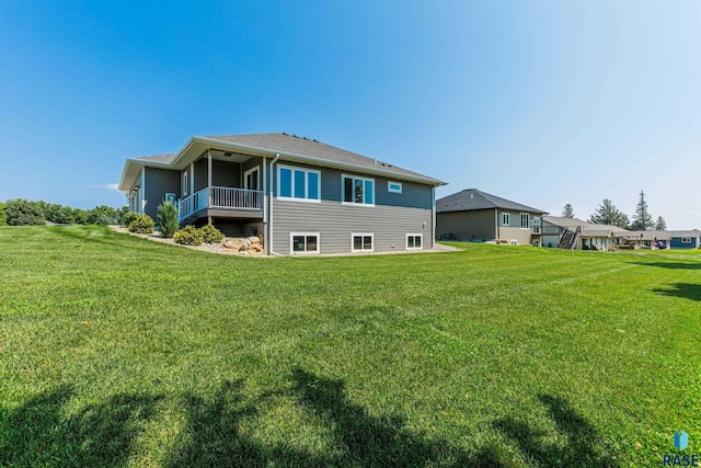 rear view of property featuring a yard