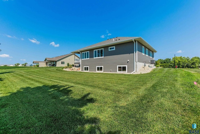 back of house with a lawn