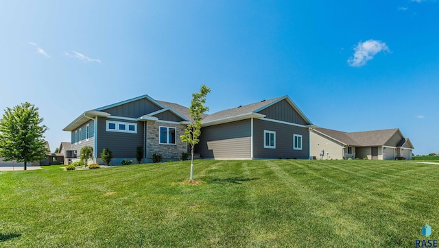view of side of property with a lawn and board and batten siding