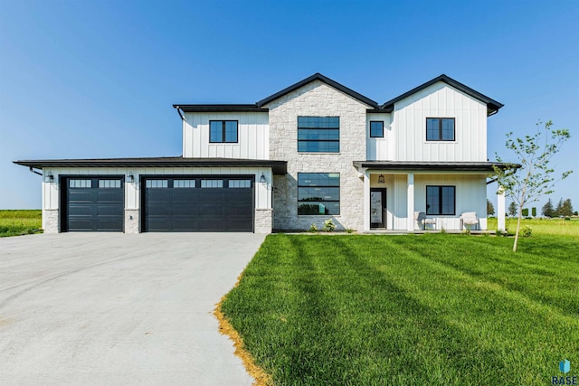 modern inspired farmhouse featuring a front yard and a garage