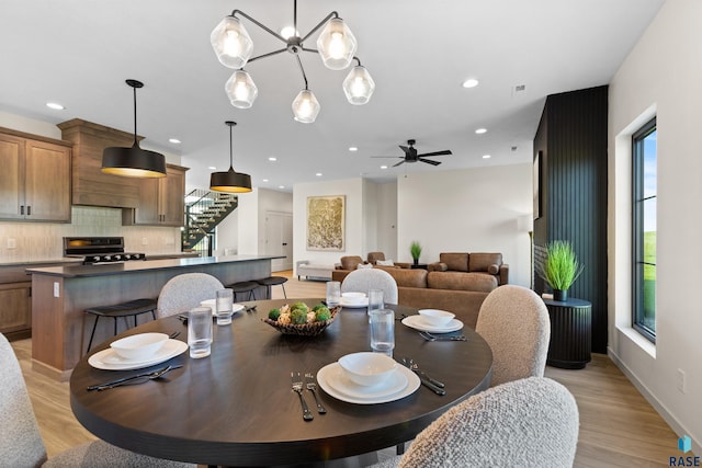 dining space featuring ceiling fan, light wood-style flooring, recessed lighting, and stairway