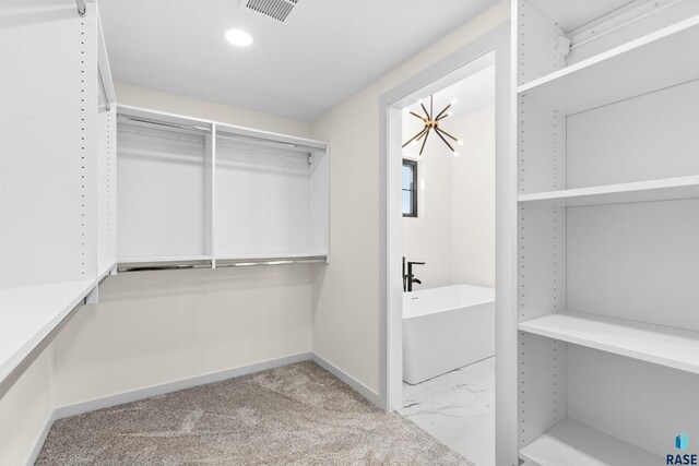 walk in closet featuring visible vents and carpet