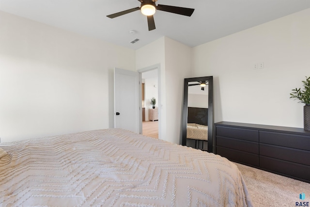 carpeted bedroom with visible vents and ceiling fan