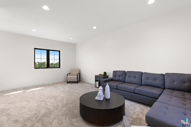 carpeted living room featuring baseboards and recessed lighting