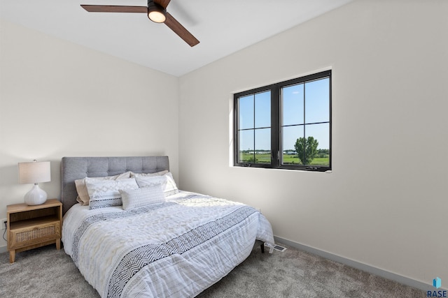 carpeted bedroom featuring visible vents, baseboards, and ceiling fan