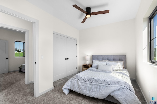 bedroom with baseboards, carpet flooring, a closet, and ceiling fan