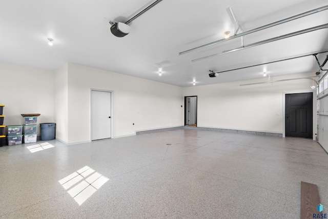 garage featuring baseboards and a garage door opener