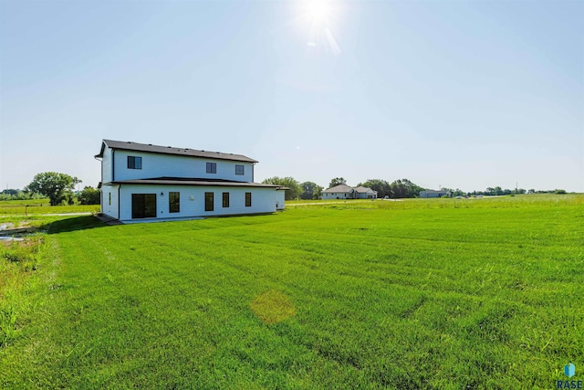 rear view of property featuring a yard