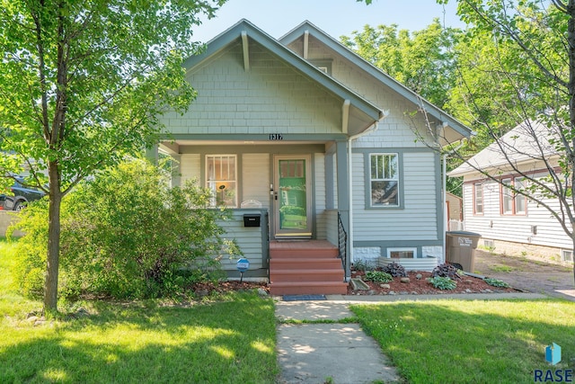 bungalow-style home featuring a front lawn