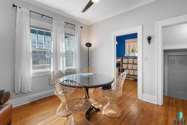 dining room with crown molding and hardwood / wood-style floors