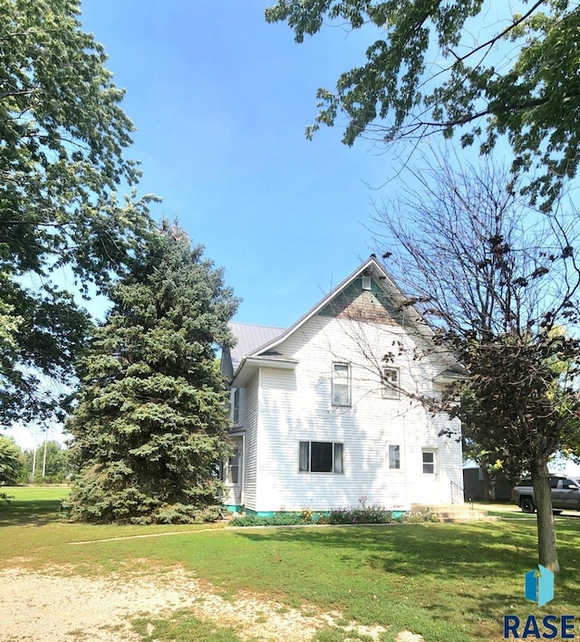 view of side of property with a yard