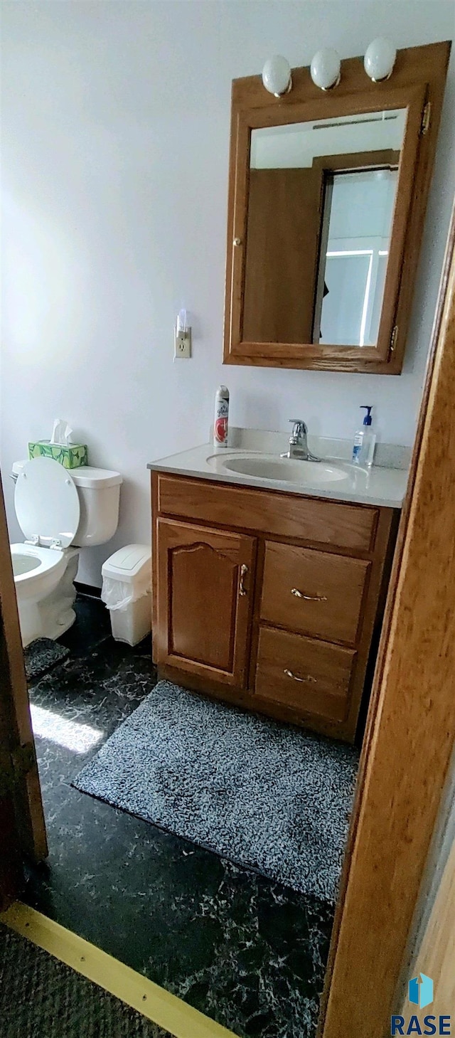 bathroom featuring vanity and toilet