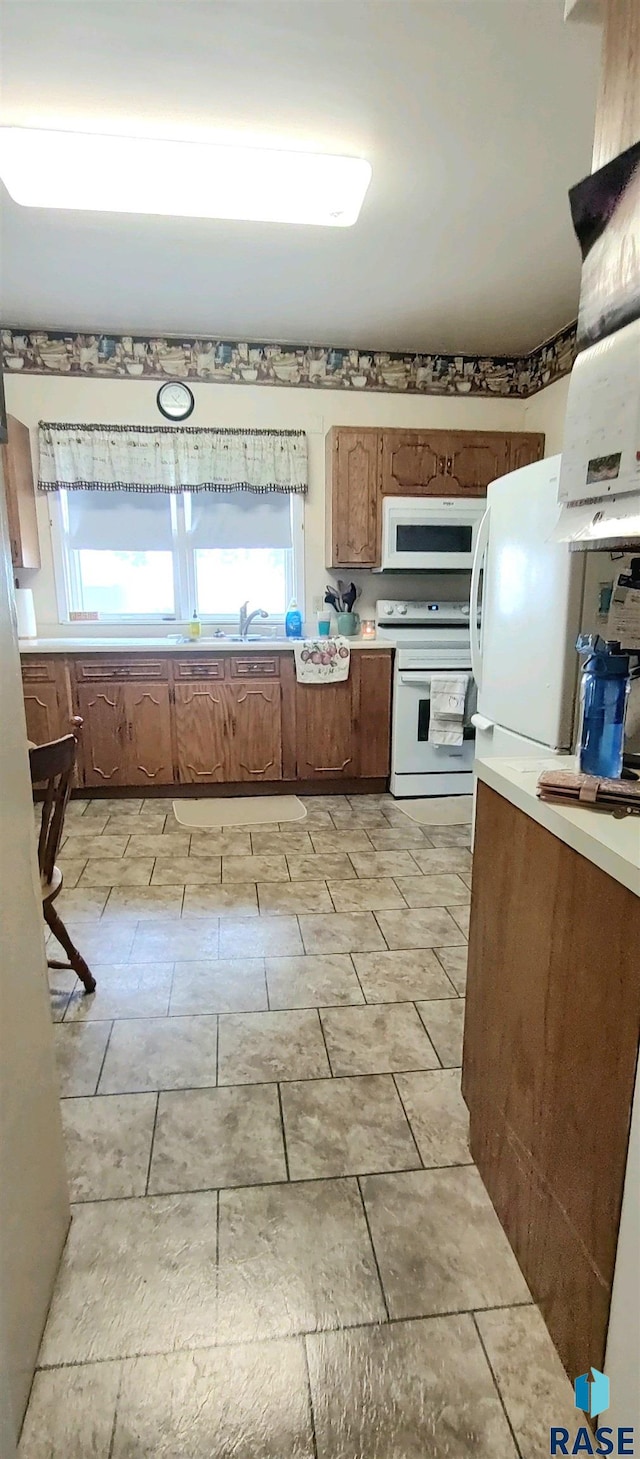 kitchen featuring sink and white appliances