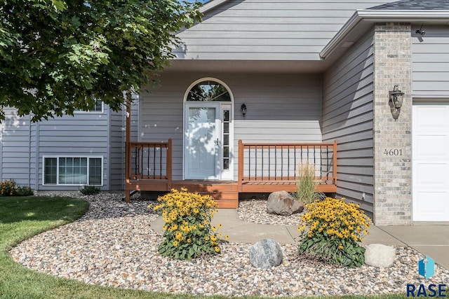 view of exterior entry featuring a garage