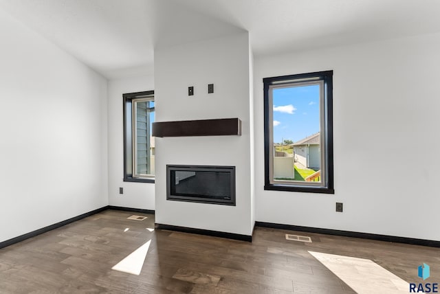 unfurnished living room featuring dark hardwood / wood-style flooring